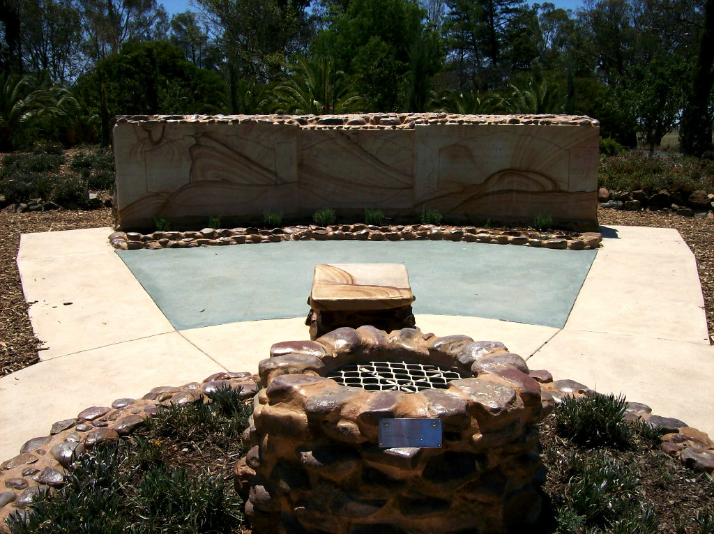sandstone monument and wishing-well